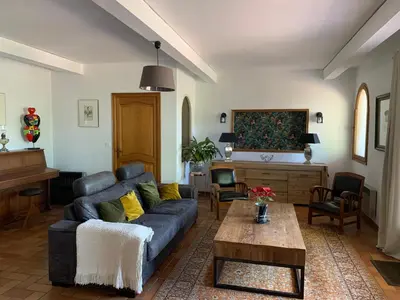 a living room with a blue couch and a table at Villa Sainte BARBE in Loriol-du-Comtat