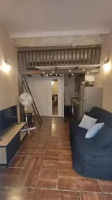 a living room with a couch and a loft at La cachette d'Aix in Aix-en-Provence