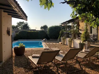 a patio with chairs and a swimming pool at Haus PETIT REVE in Oppède in Oppède
