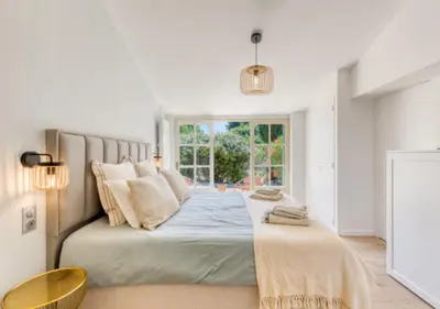 a bedroom with a large bed with a window at Villa La Belle Vie in Gordes