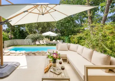 a living room with a white couch and an umbrella at Villa La Belle Vie in Gordes
