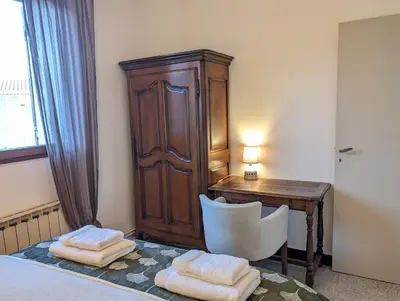 a bedroom with a desk and a chair and a wooden cabinet at LE CHESTER - Maison de charme en Provence avec piscine près de L'Isle-sur-la-Sorgue in Velleron