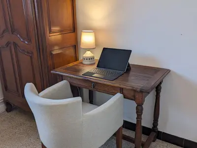 a desk with a laptop and a lamp on it at LE CHESTER - Maison de charme en Provence avec piscine près de L'Isle-sur-la-Sorgue in Velleron