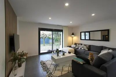 a living room with a couch and a table at Villa rosalie L'Isle-sur-la-Sorgue in LʼIsle-sur-la-Sorgue