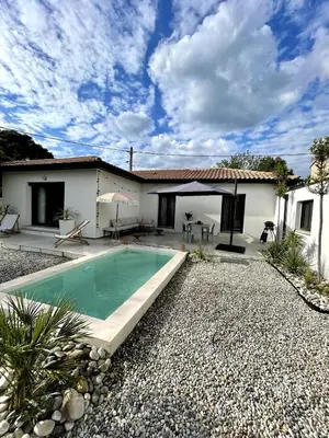 a villa with a swimming pool in front of a house at Villa rosalie L'Isle-sur-la-Sorgue in LʼIsle-sur-la-Sorgue