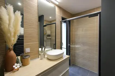 a bathroom with a white sink and a shower at Villa rosalie L'Isle-sur-la-Sorgue in LʼIsle-sur-la-Sorgue