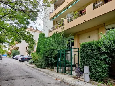 a building with a gate on the side of a street at Provence apartments in Aix-en-Provence