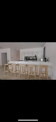 a kitchen with a table and four stools at Villa contemporaine de luxe in Aix-en-Provence