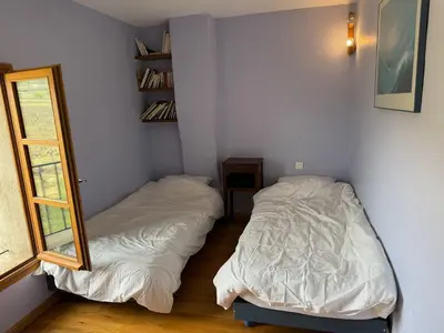a bedroom with two beds and a mirror at Bastide Neuve au Cœur du Luberon - Piscine Privée in Lauris