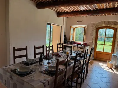 a dining room with a long table and chairs at Bastide Neuve au Cœur du Luberon - Piscine Privée in Lauris