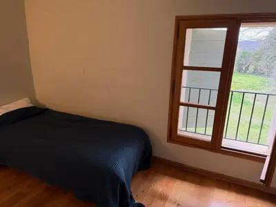 a bedroom with a bed next to a window at Bastide Neuve au Cœur du Luberon - Piscine Privée in Lauris