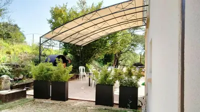 an arbor with potted plants in a garden at Tranquil Cottage With Views Of Mont Ventoux in Les Gaps