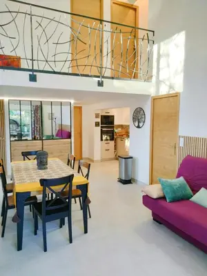 a dining room and living room with a table and a couch at Tranquil Cottage With Views Of Mont Ventoux in Les Gaps