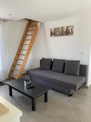 a living room with a couch and a coffee table at Un jour en Provence in Cabannes