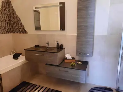 a bathroom with a sink and a mirror and a tub at Maison en Provence in Jouques