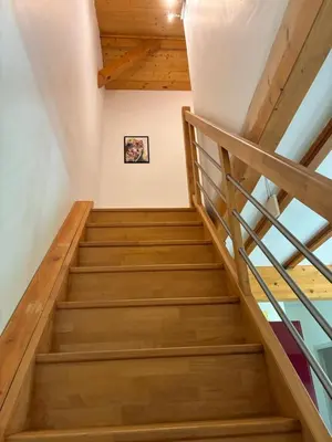a staircase in a house with wooden ceilings at Au doux paillis Sorgue in Le Thor