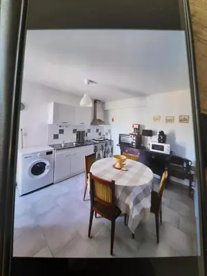 a kitchen and dining room with a table and chairs at Mamimonik in Lauris
