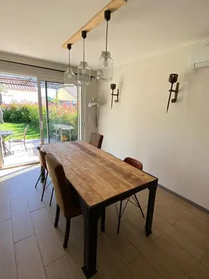 a dining room with a wooden table and chairs at Quiet house in provence in Lauris