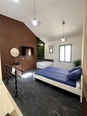 a bedroom with a bed and a bath tub at jungle room in La Tour-dʼAigues