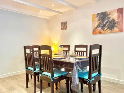 a dining room with a table and four chairs at Miraluna - Village médiéval, calme, insolite, 6 personnes in Miramas