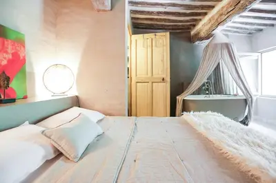 a bedroom with a large bed and a window at La Grande Bergerie in Saint-Saturnin-les-Apt
