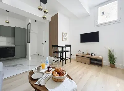 a living room with a table with a bowl of bread at Côté Palmier - Luxurious 2-room - Center-by PauseAixoise in Aix-en-Provence