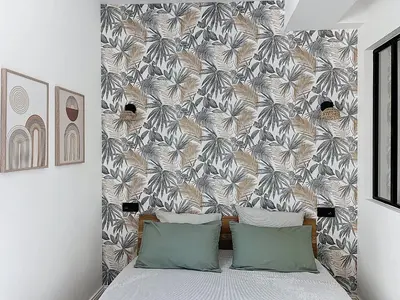a bed with two pillows in front of a wall at Côté Palmier - Luxurious 2-room - Center-by PauseAixoise in Aix-en-Provence