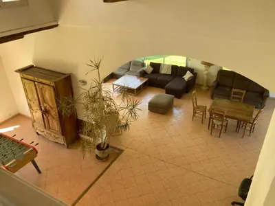 a living room with a couch and a table at Grande maison avec piscine in Aix-en-Provence