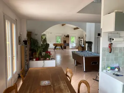 a kitchen and dining room with a table in a room at Grande maison avec piscine in Aix-en-Provence