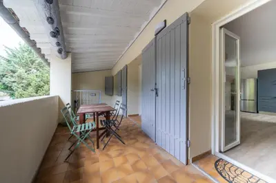 a room with a table and chairs and a door at Maison proche Avignon Clim Terrasse wifi 4pers in Jonquerettes