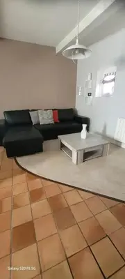 a living room with a couch and a table at Maison conviviale avec jardin à Revest-des-Brousses in Vachères