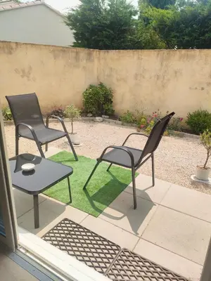 two chairs and a table on a patio at Mayka in LʼIsle-sur-la-Sorgue