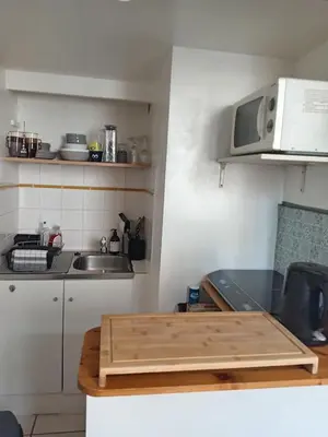 a kitchen with a counter with a sink and a microwave at Charmant studio centre historique Aix in Aix-en-Provence