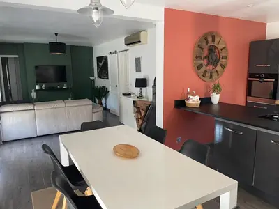 a kitchen and living room with a table and chairs at Villa de caractères,piscine, vue sur le luberon,3 chambres in Cheval-Blanc