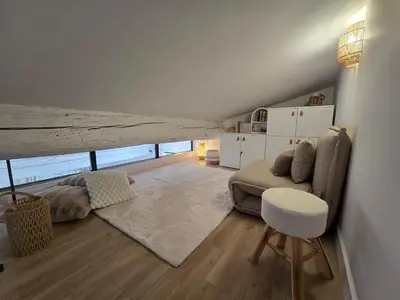 a living room with a couch and a table at le logis des roues in LʼIsle-sur-la-Sorgue