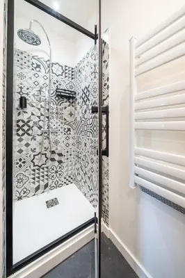 a shower stall with a glass door in a bathroom at le logis des roues in LʼIsle-sur-la-Sorgue