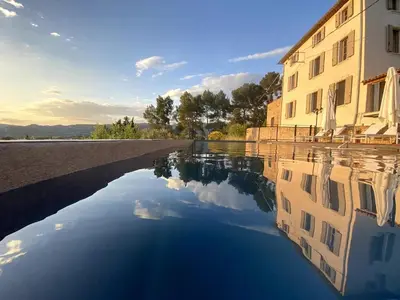 a reflection of a building in a body of water at Exceptional Bastide in Lourmarin, Luberon in Lourmarin