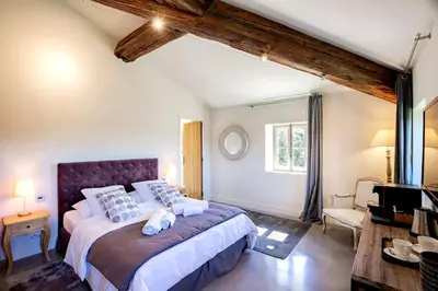 a bedroom with a large bed in a room at Exceptional Bastide in Lourmarin, Luberon in Lourmarin