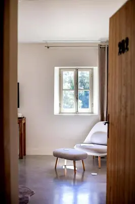 a living room with a bench and a window at Exceptional Bastide in Lourmarin, Luberon in Lourmarin