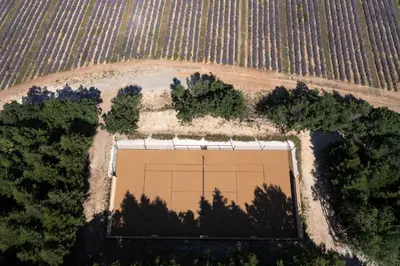 an overhead view of a tennis court in a field at Domaine Château du Bois Provence in Lagarde-dʼApt