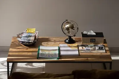 a table with a fan and books on it at Dolce Vita Piscine in LʼIsle-sur-la-Sorgue
