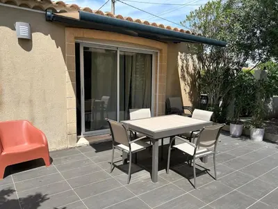 a table and chairs sitting on a patio at Villa Serena - 3 chambres grand confort - 6 personnes in Carpentras