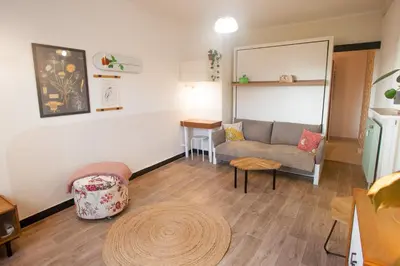 a living room with a couch and a table at La Mazarine - Studio tout confort - Les Milles proche Aix TGV Marseille in Aix-en-Provence