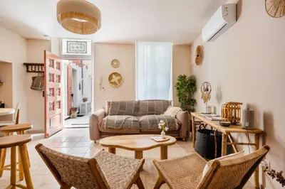 a living room with a couch and chairs at La Cour Secrète - Suite Bali Balnéo privé Carpentras in Carpentras