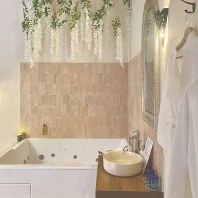 a bathroom with a tub and a sink and a bath tub at La Cour Secrète - Suite Riad Balnéo privé Carpentras in Carpentras