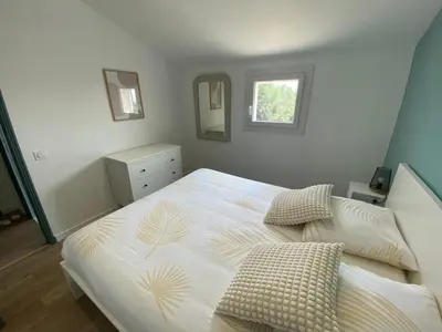 a bedroom with a large white bed with two pillows at Maison Aix-en-Provence in Aix-en-Provence