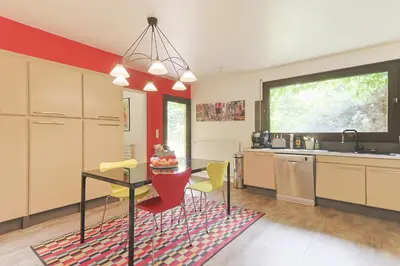 a kitchen with a table and chairs in a kitchen at Villa des Pres in Eyragues