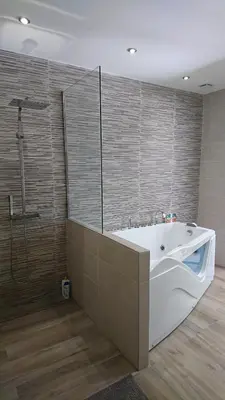 a bathroom with a white tub and a shower at Chamarte villa piscine chauffées jardin clôturé Aix en Provence in Aix-en-Provence