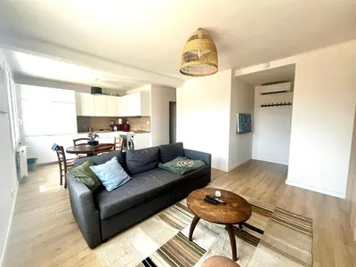 a living room with a couch and a table at Aix centre - Appartement Cosy avec Terrasse et Clim in Aix-en-Provence