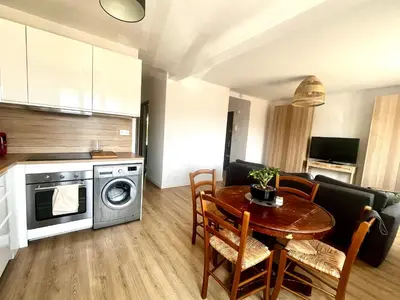 a kitchen and living room with a table and a dining room at Aix centre - Appartement Cosy avec Terrasse et Clim in Aix-en-Provence